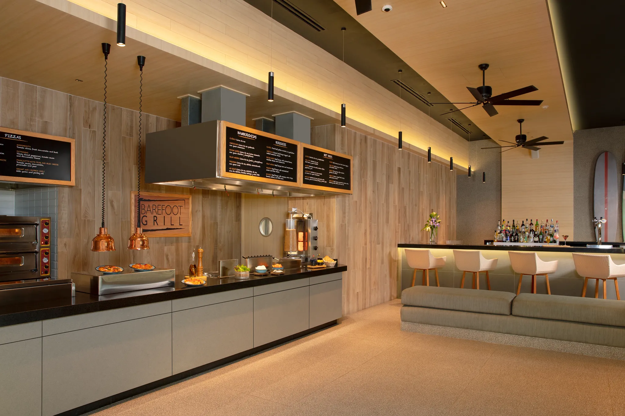 Barefoot Grill at Secrets Bahia Mita Surf & Spa Resort featuring an open-air casual lunch spot with pizzas, burgers, and relaxed resort seating.