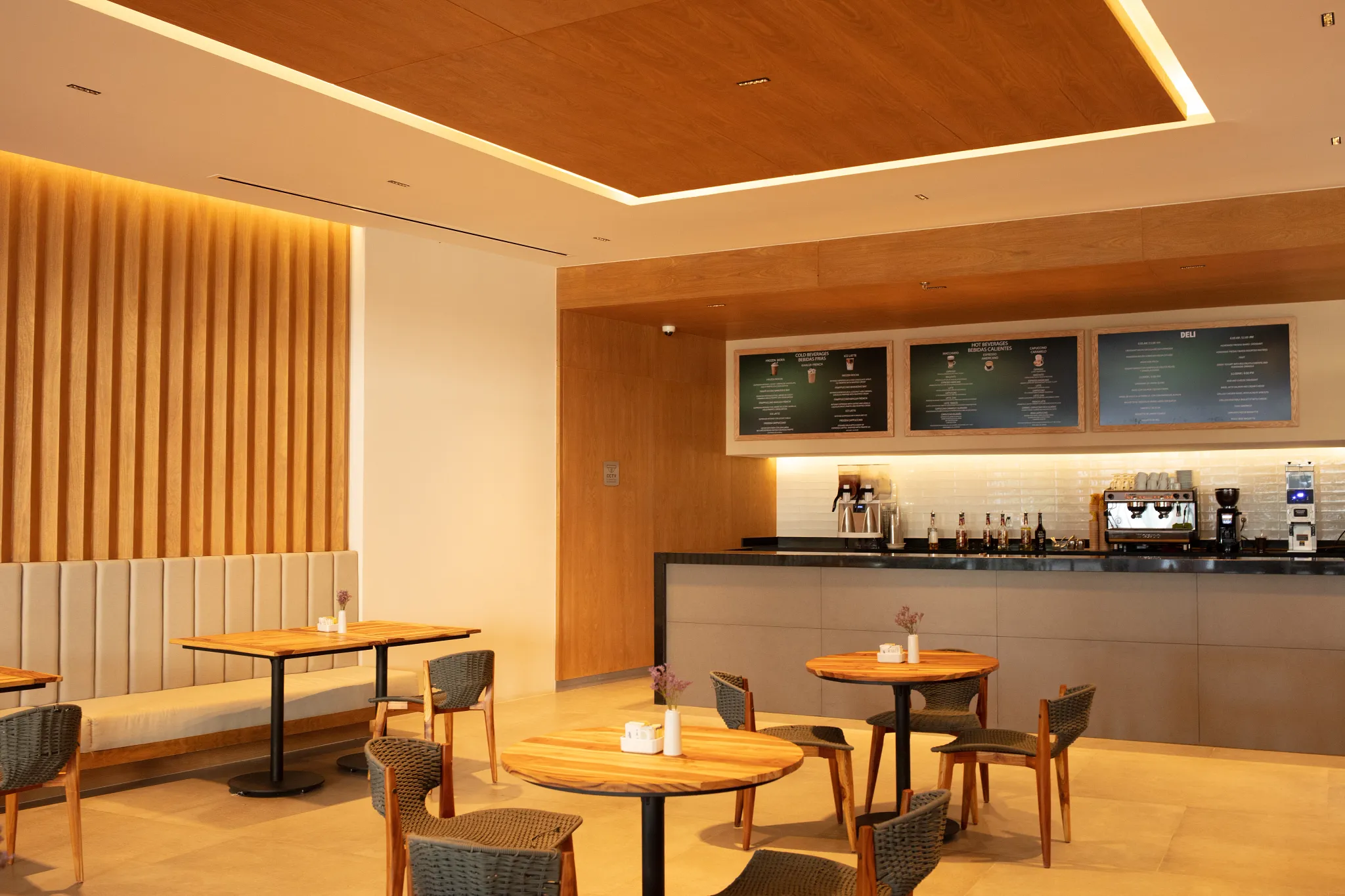 Coco Café & Gelato at Secrets Bahia Mita Surf & Spa Resort featuring a modern coffee bar with warm wood accents, cozy seating, and freshly made pastries and gelato.