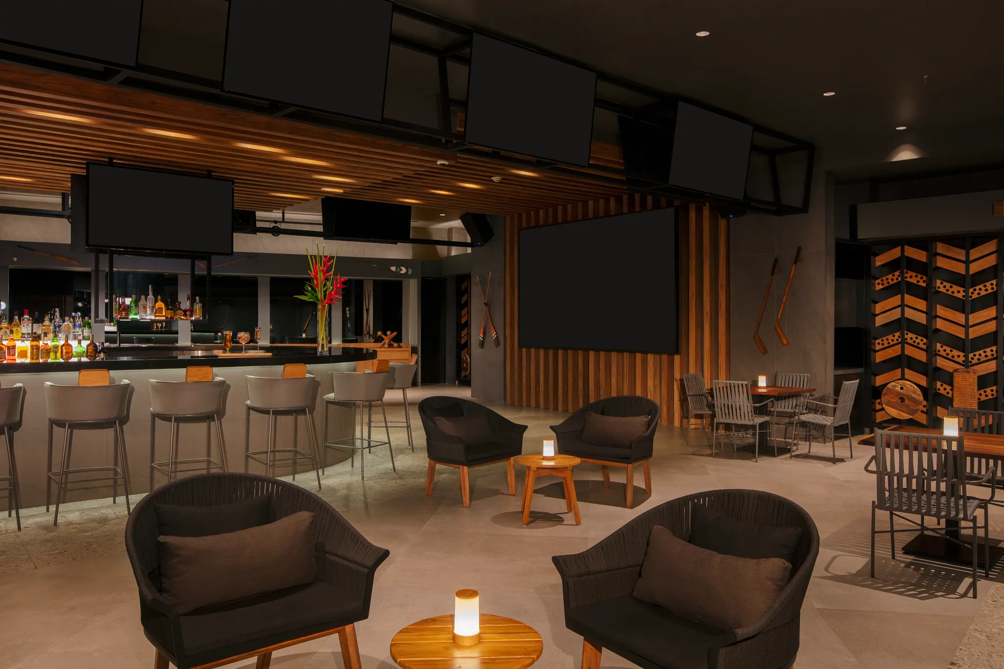 Desires Sports Bar at Secrets Bahia Mita Surf & Spa Resort featuring a modern lounge with large screens, full bar, and relaxed seating.