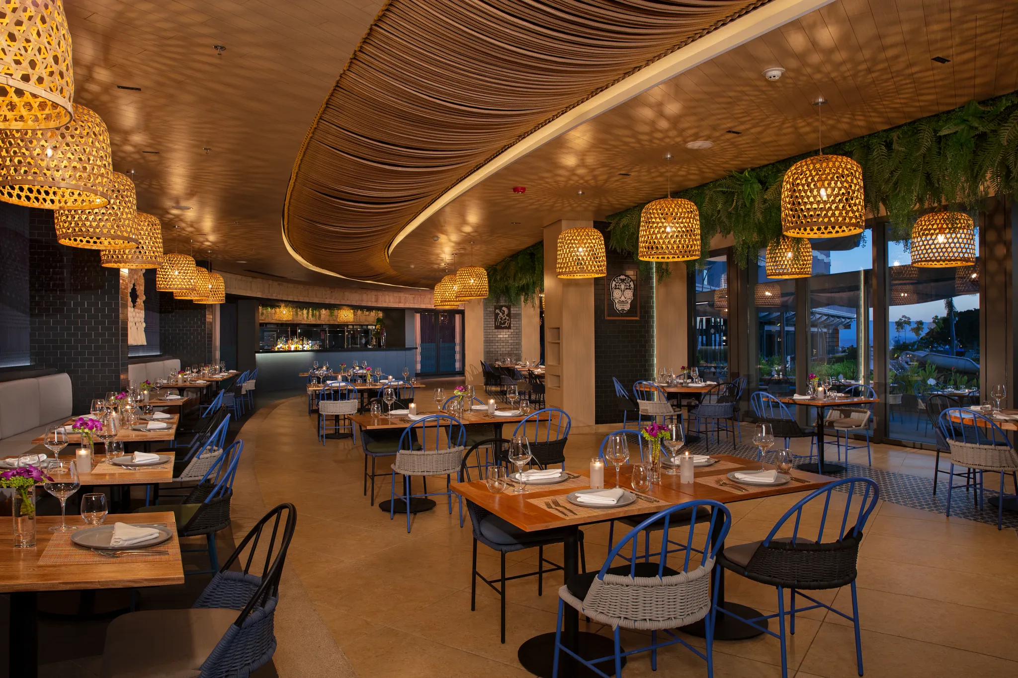 El Patio Mexican Restaurant at Secrets Bahia Mita Surf & Spa Resort featuring a warm, traditional dining room with handcrafted décor and elegant table settings.