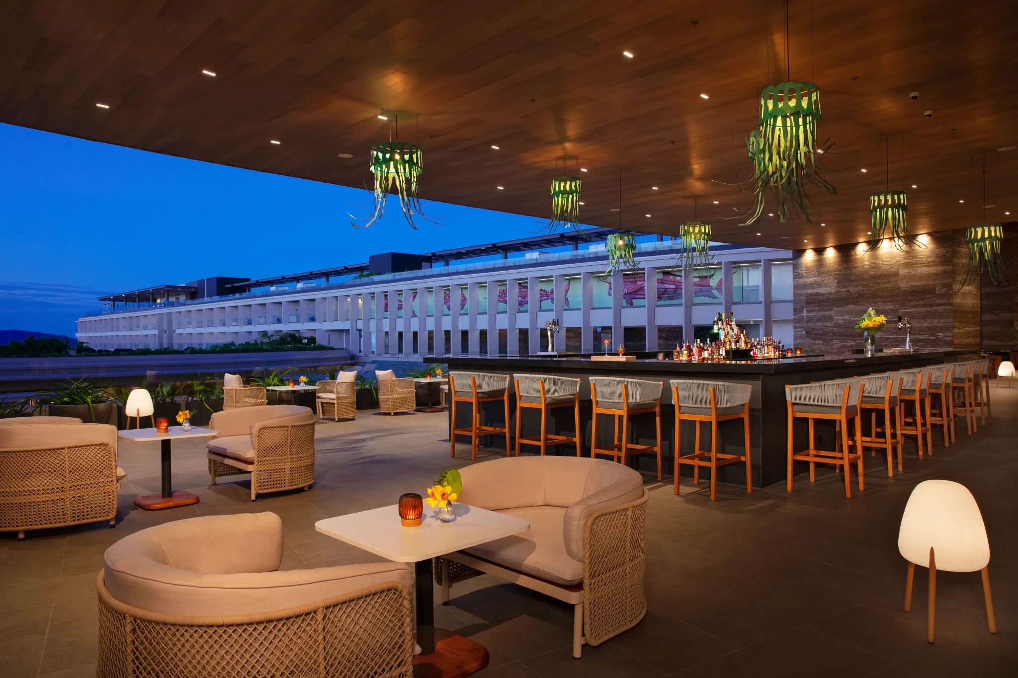 Interlude Lobby Bar at Secrets Bahia Mita Surf & Spa Resort featuring a stylish open-air lounge with chic décor, comfortable seating, and a modern bar.