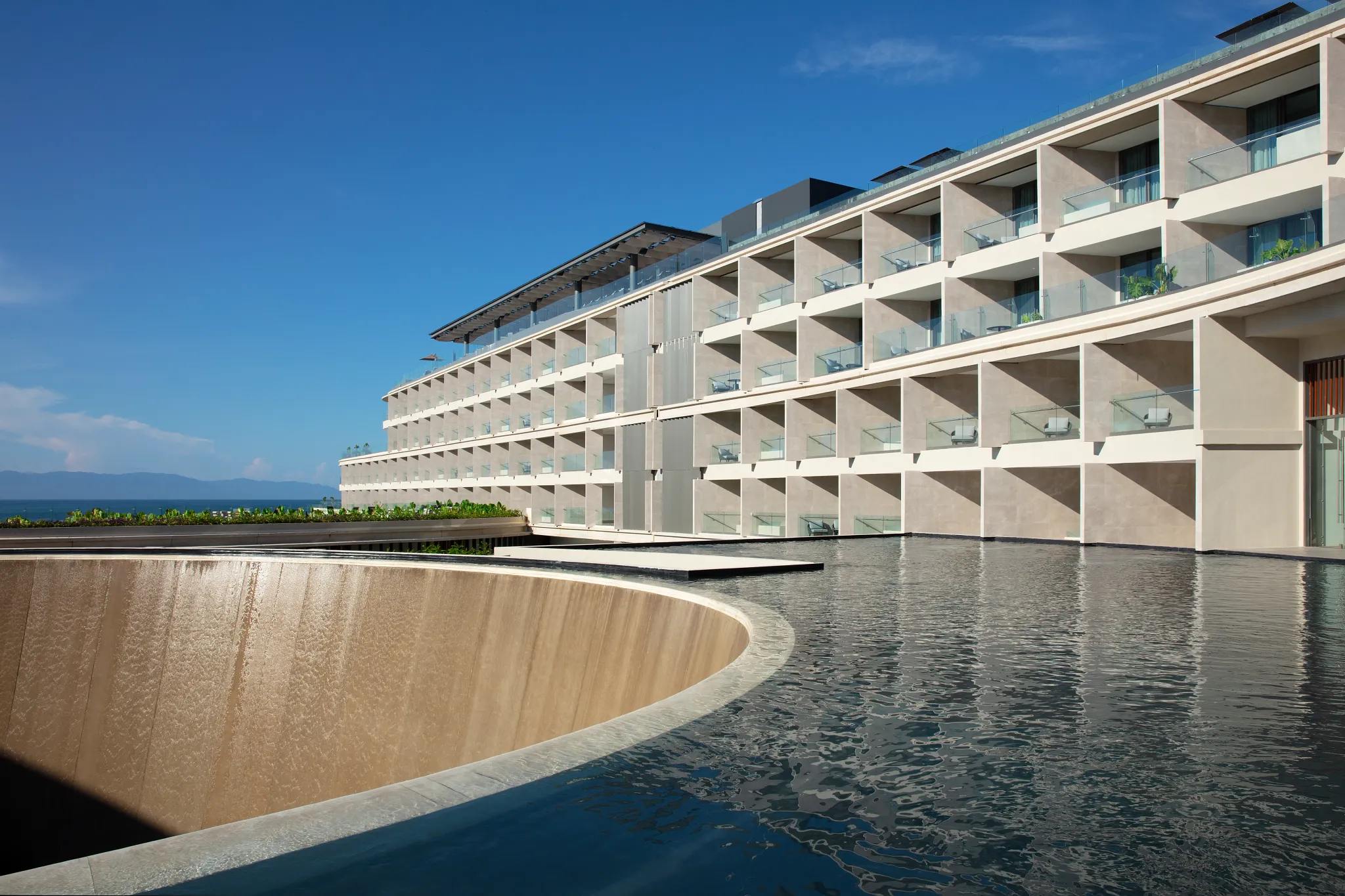Modern mirror fountain water feature at Secrets Bahia Mita Surf & Spa Resort reflecting contemporary architecture.