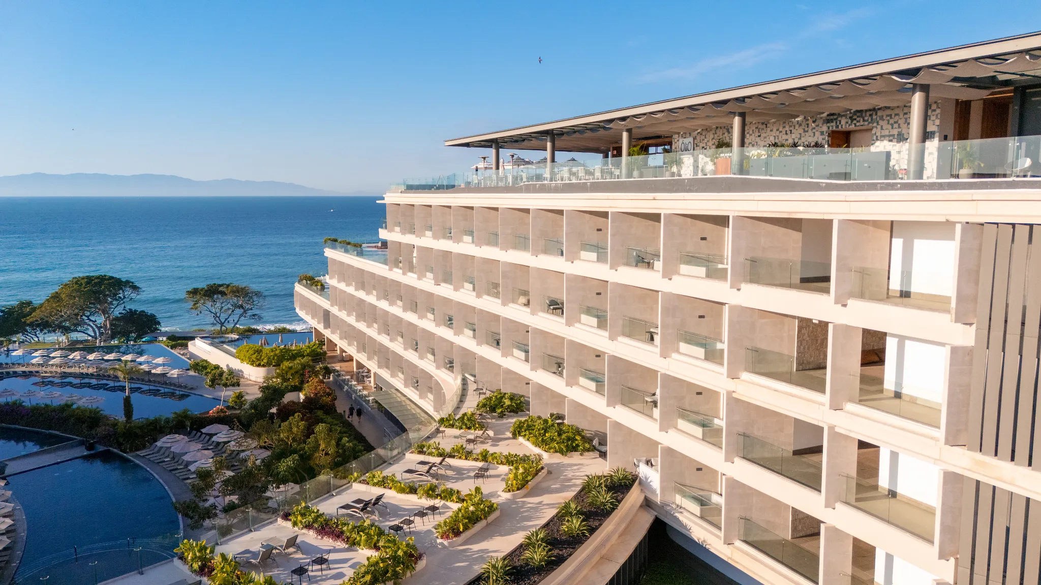 Oceanview sun deck and infinity pool at Secrets Bahia Mita Surf & Spa Resort overlooking the Pacific coastline.