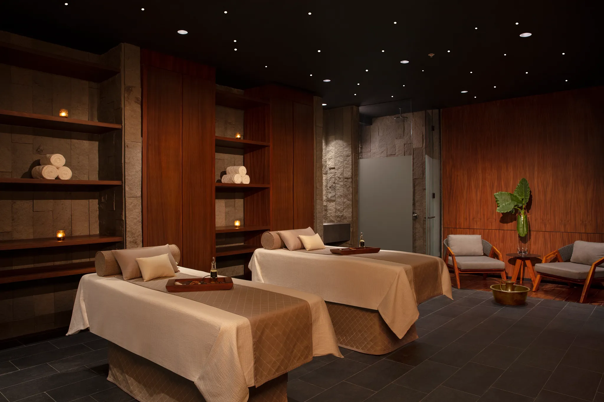 Couples massage suite at Secrets Bahía Mita Surf & Spa Resort featuring serene lighting and luxury spa beds.