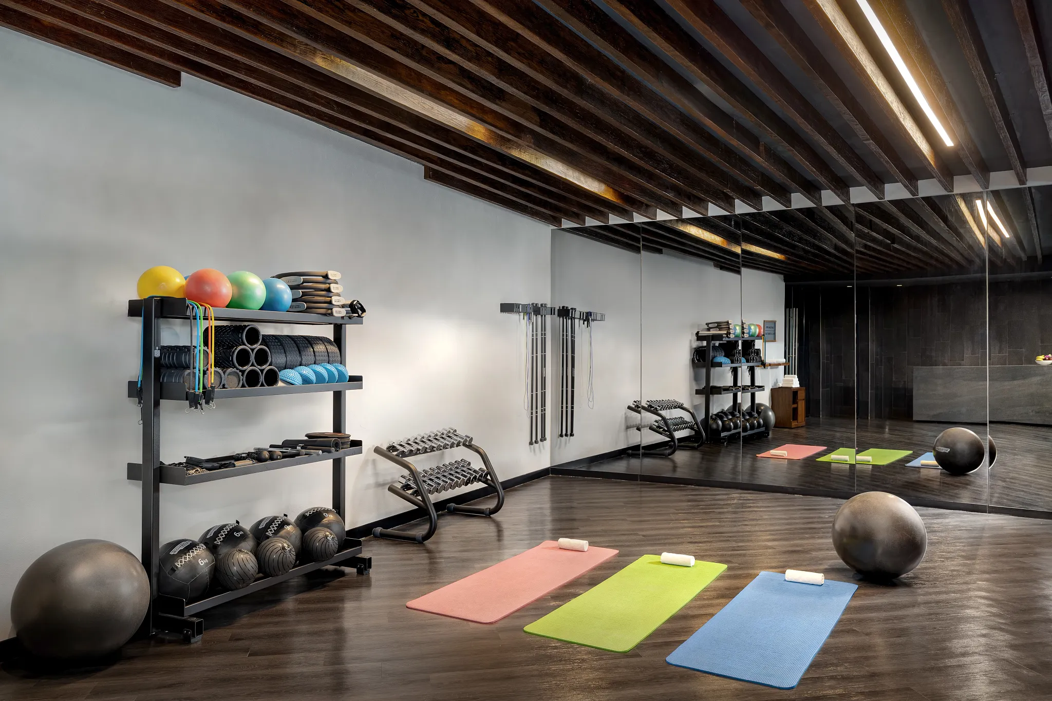 Modern fitness and yoga studio with exercise mats and equipment at Secrets Bahia Mita Surf & Spa Resort.