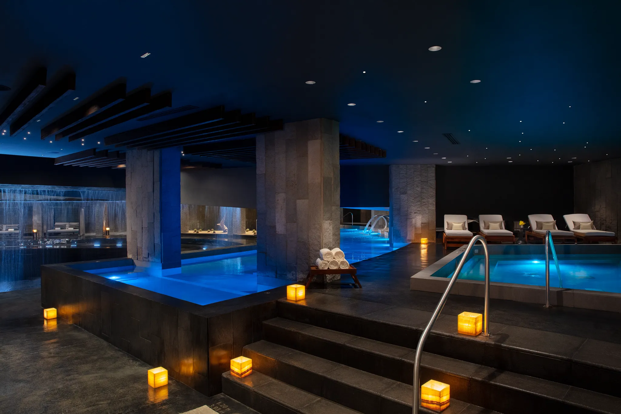Hydrotherapy circuit with soaking pools and lounge chairs at Secrets Bahía Mita Surf & Spa Resort.