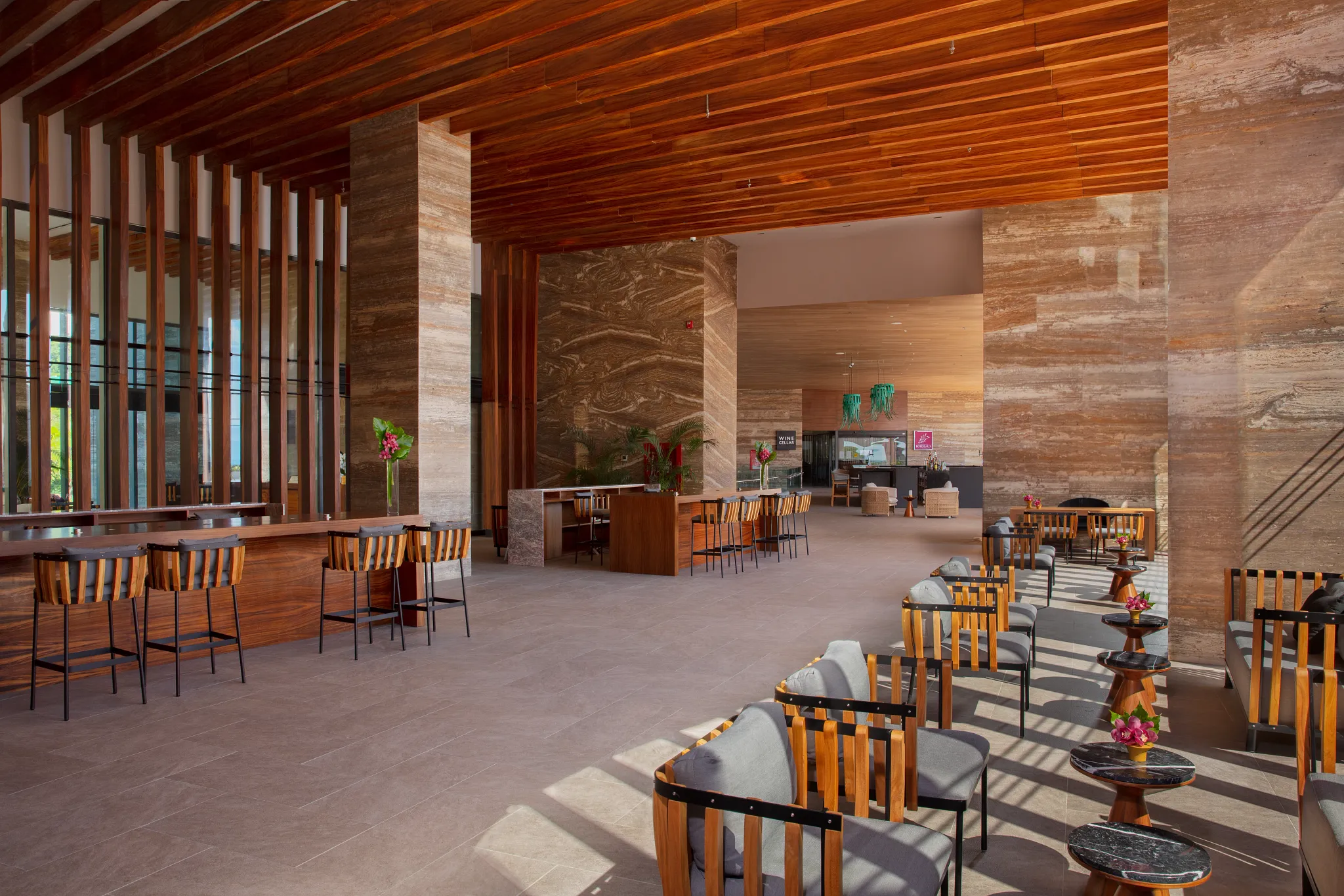 Open-air main lobby at Secrets Bahía Mita Surf & Spa Resort with contemporary seating and ocean-inspired architecture.
