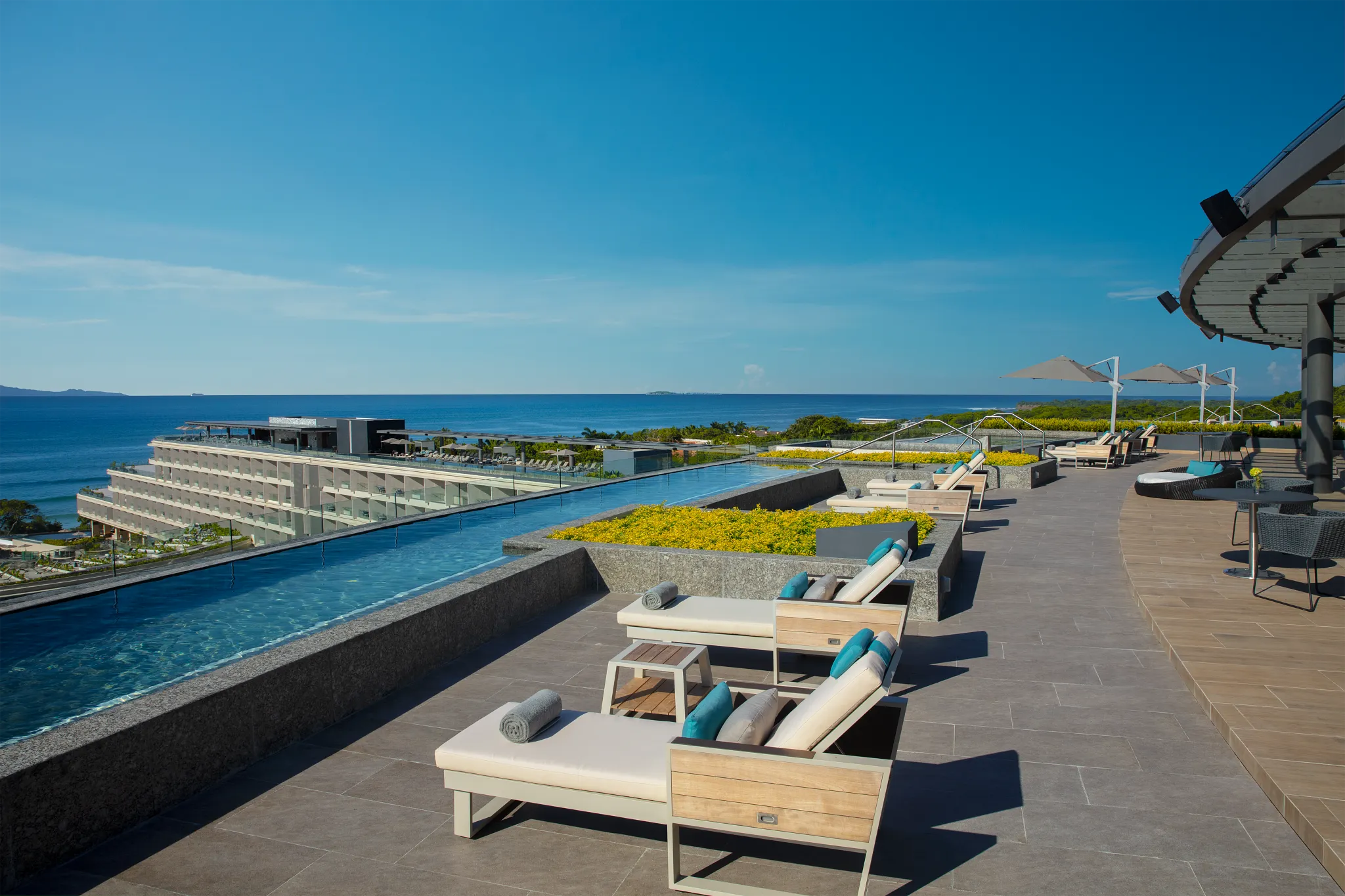 Rooftop infinity pool with ocean views at Secrets Bahia Mita Surf & Spa Resort.