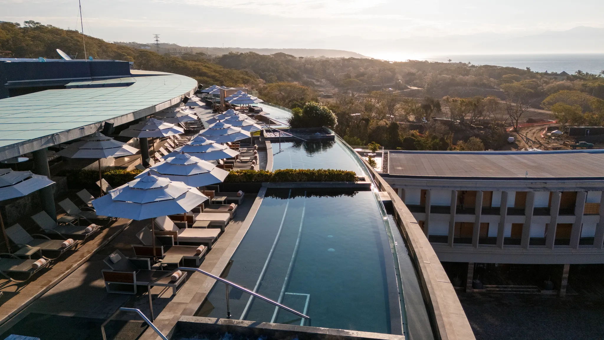 Sky Bar at Secrets Bahia Mita Surf & Spa Resort featuring a rooftop open-air lounge with infinity pool views, chic décor, and panoramic ocean scenery.