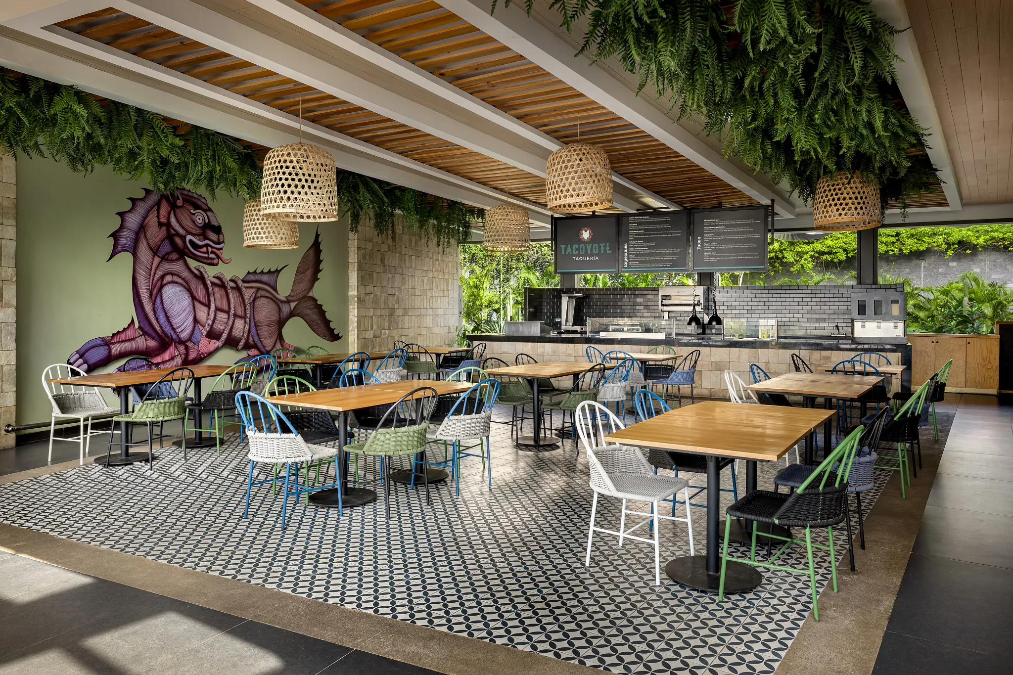 Tacoyotl Taquería at Secrets Bahia Mita Surf & Spa Resort featuring a casual open-air Mexican restaurant with colorful seating, hanging greenery, and vibrant taquería décor.